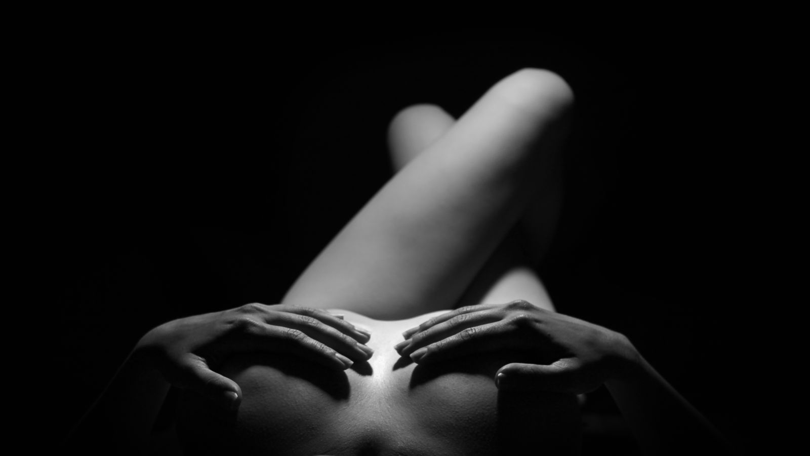 A close black and white study of hands, fingers slightly parted