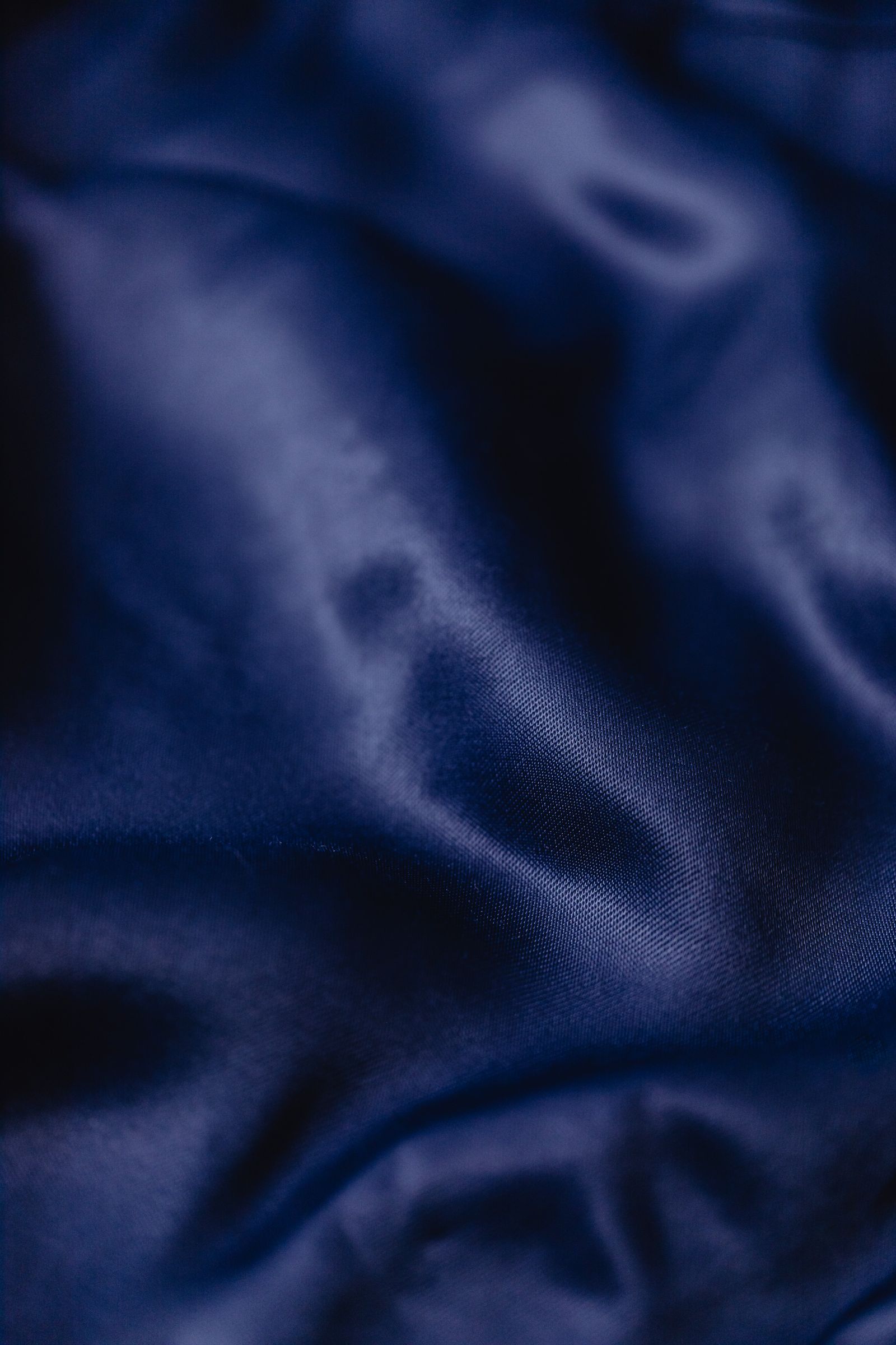 Deep blue silk drawn into taut and slackening folds